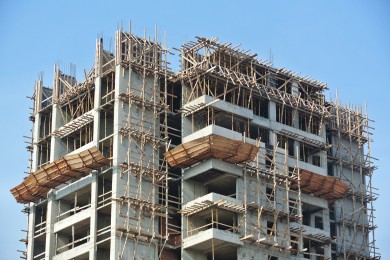 Multi-story building under construction with scaffolding