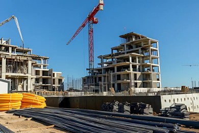 Residential buildings under construction with cranes